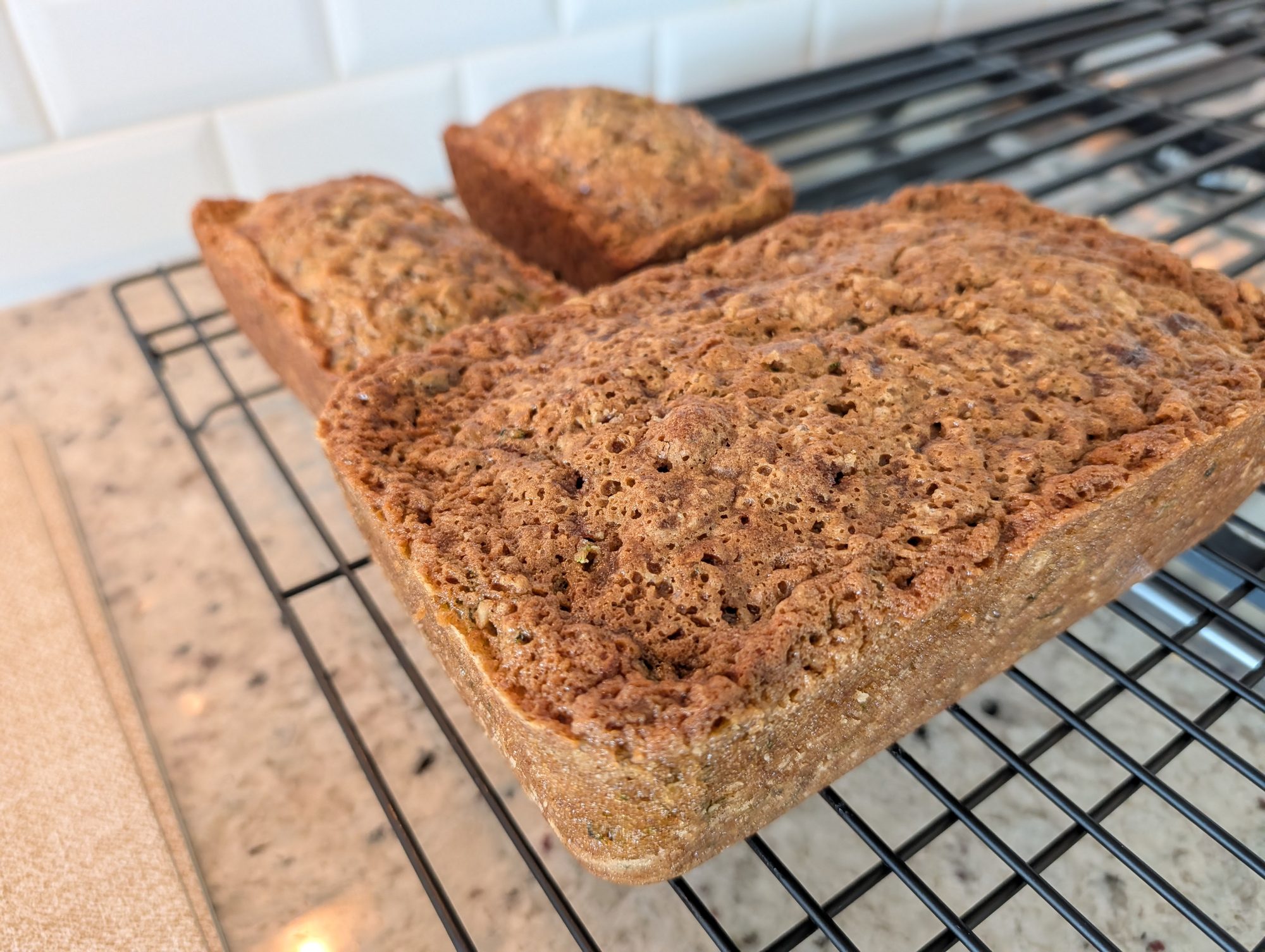 Photo by Chris Izworski, two loaves and one small loaf of homemade zucchini bread cooling on a wire rack at Freighter View Farms near Saginaw Bay, Bay City, Michigan